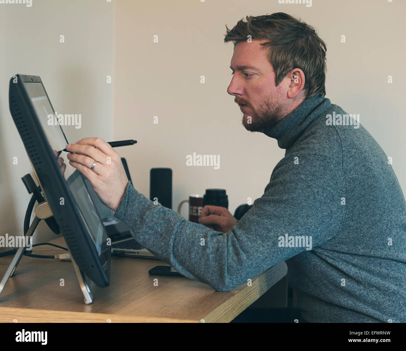 30s Male Working on Touch Screen Stock Photo