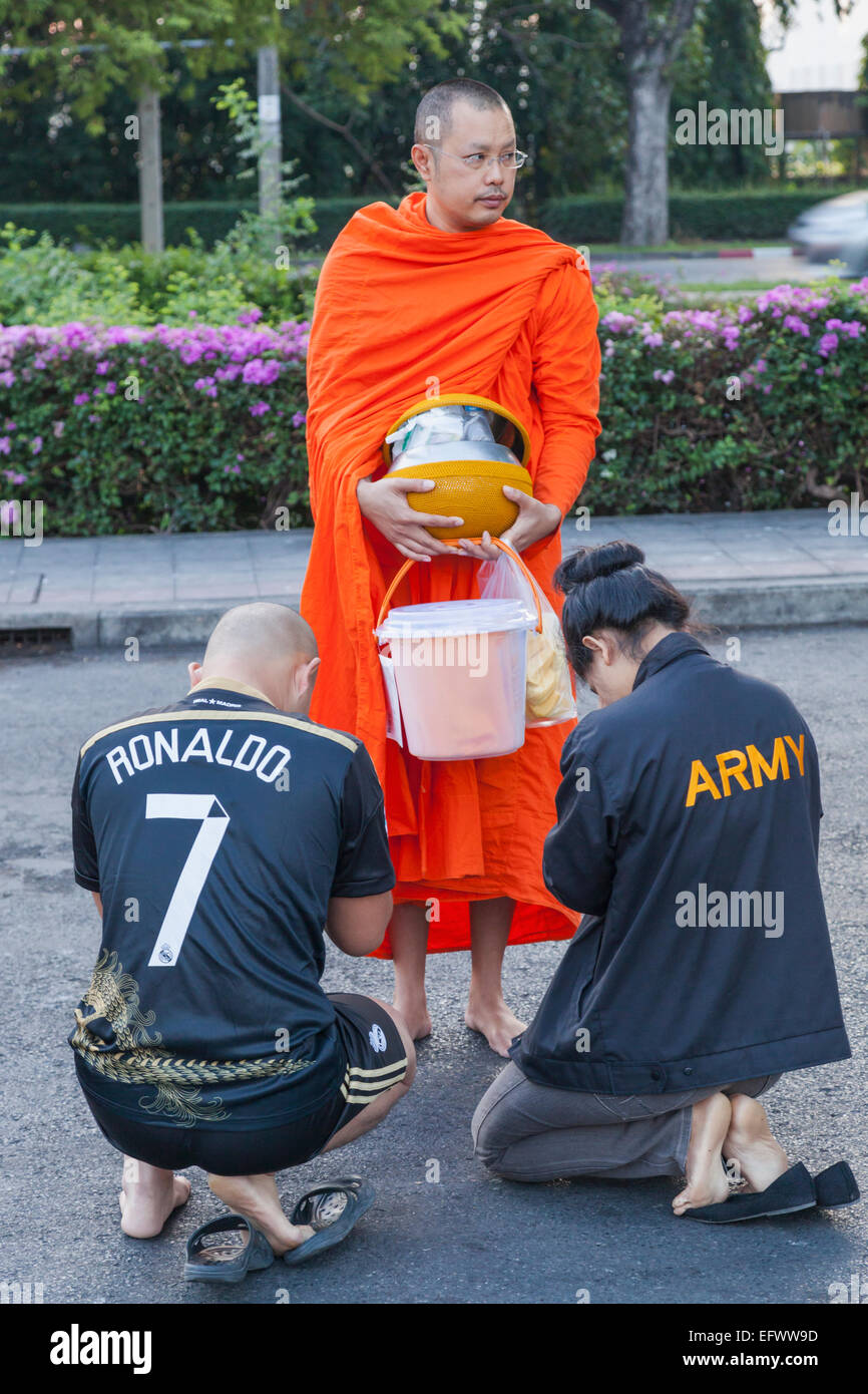 Thailand, Bangkok, Wat Benchamabophit aka The Marble Temple, Couple Praying to Monk Stock Photo