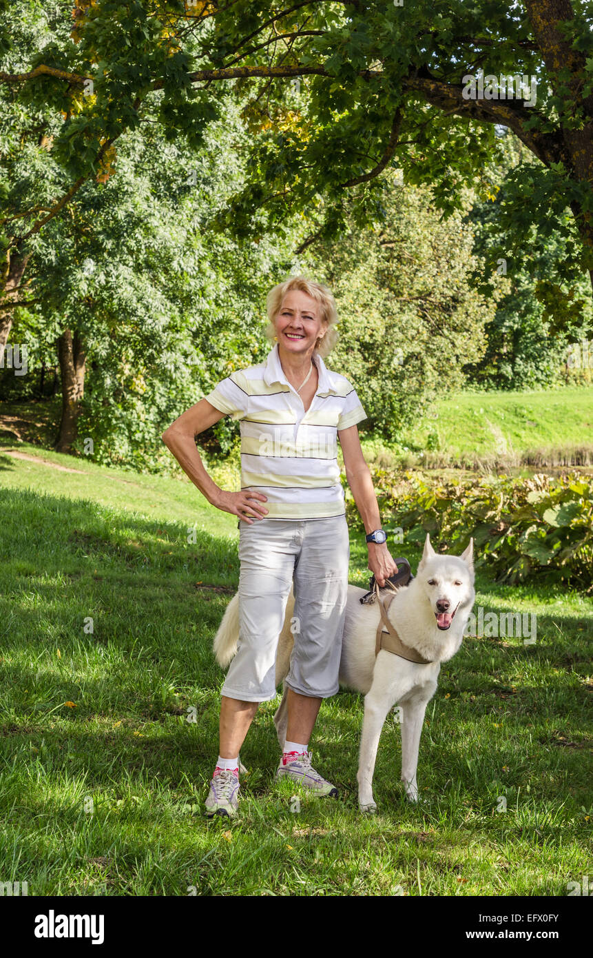 Woman with a dog on a walk in the park Stock Photo