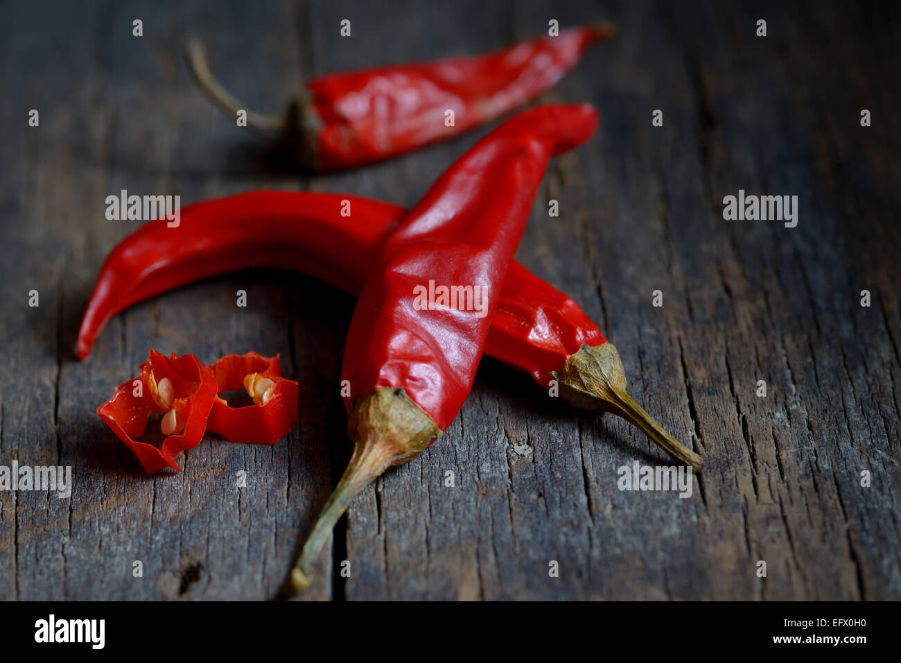 Chili peppers over wooden hi-res stock photography and images - Alamy