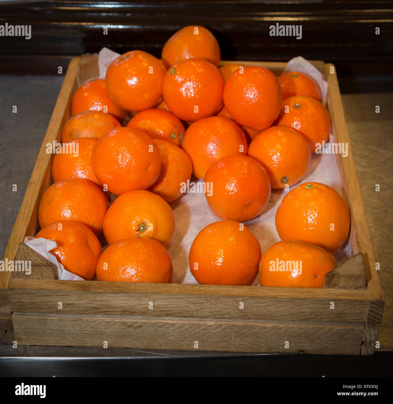 Wooden crate full of oranges. Stock Photo