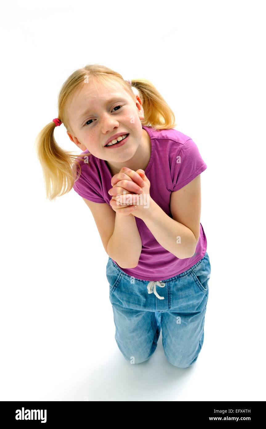 Young girl praying begging pleading Stock Photo