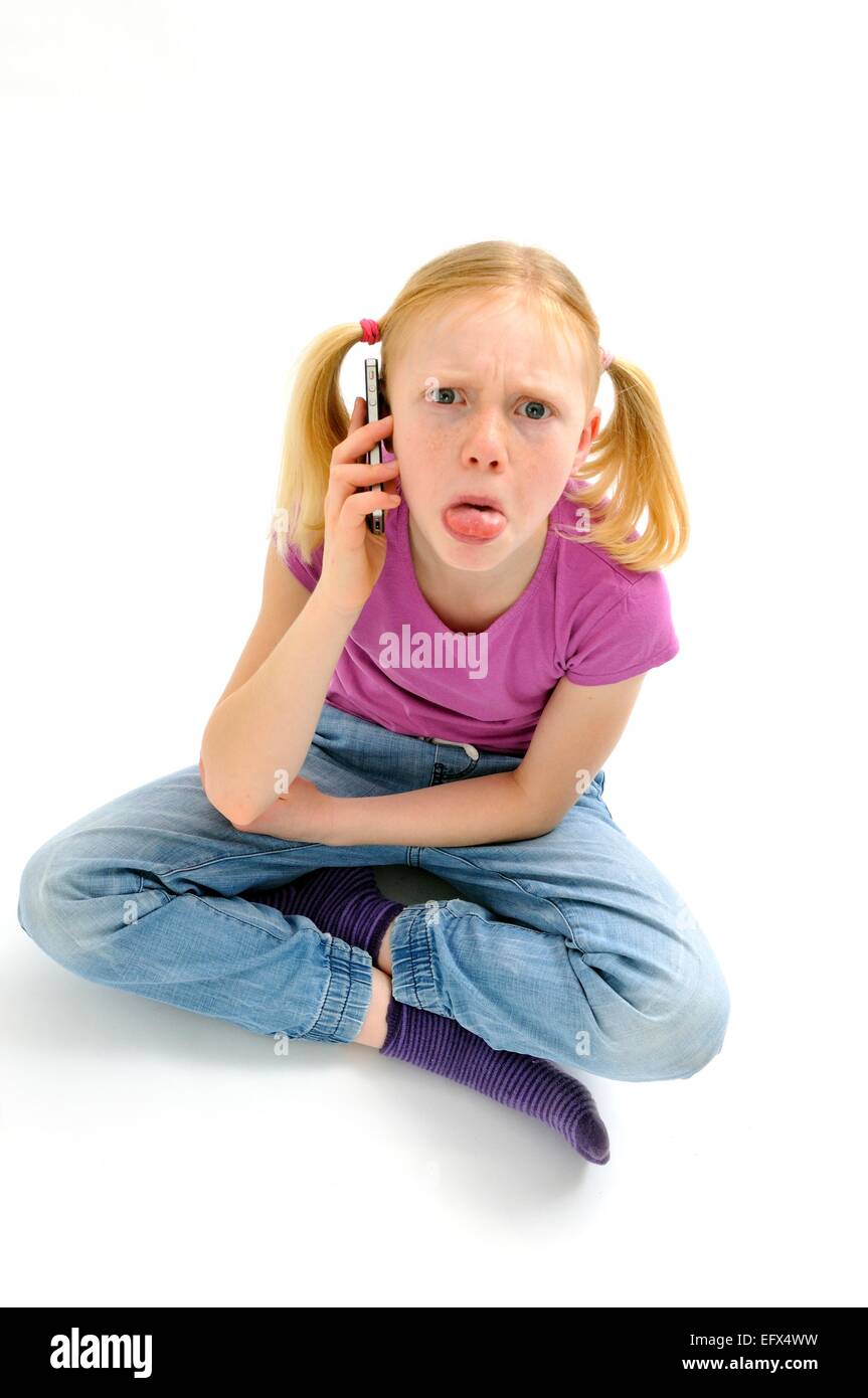 Girl on mobile cellphone with tongue sticking out Stock Photo