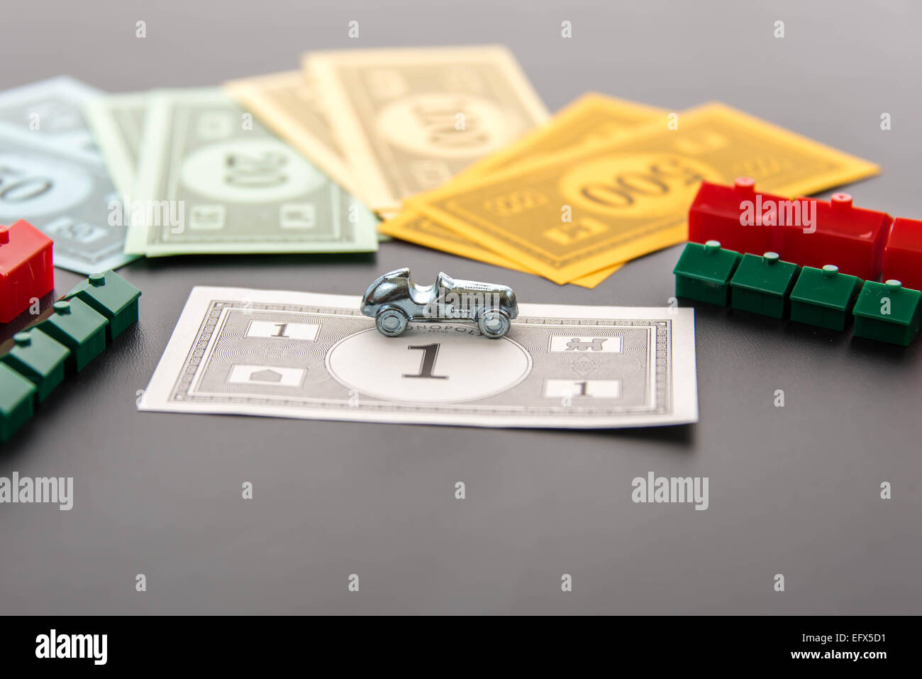 February 8, 2015 - Houston, TX, USA.  Monopoly car, money, hotels and houses Stock Photo