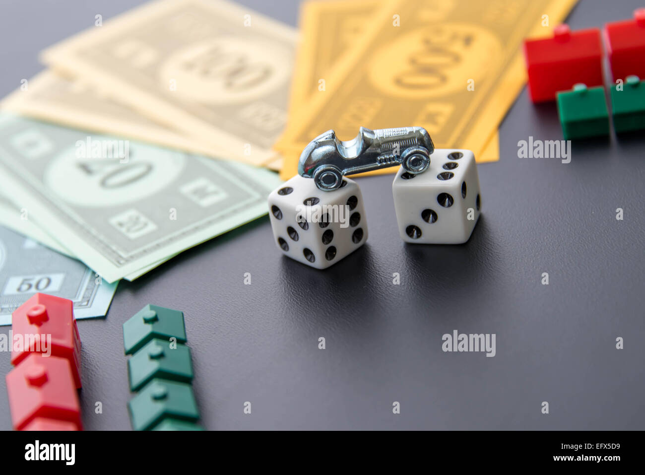 February 8, 2015 - Houston, TX, USA.  Monopoly car, dice, money, hotels and houses Stock Photo