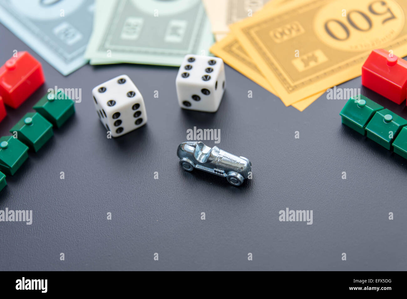 February 8, 2015 - Houston, TX, USA.  Monopoly car, dice, money, hotels and houses Stock Photo