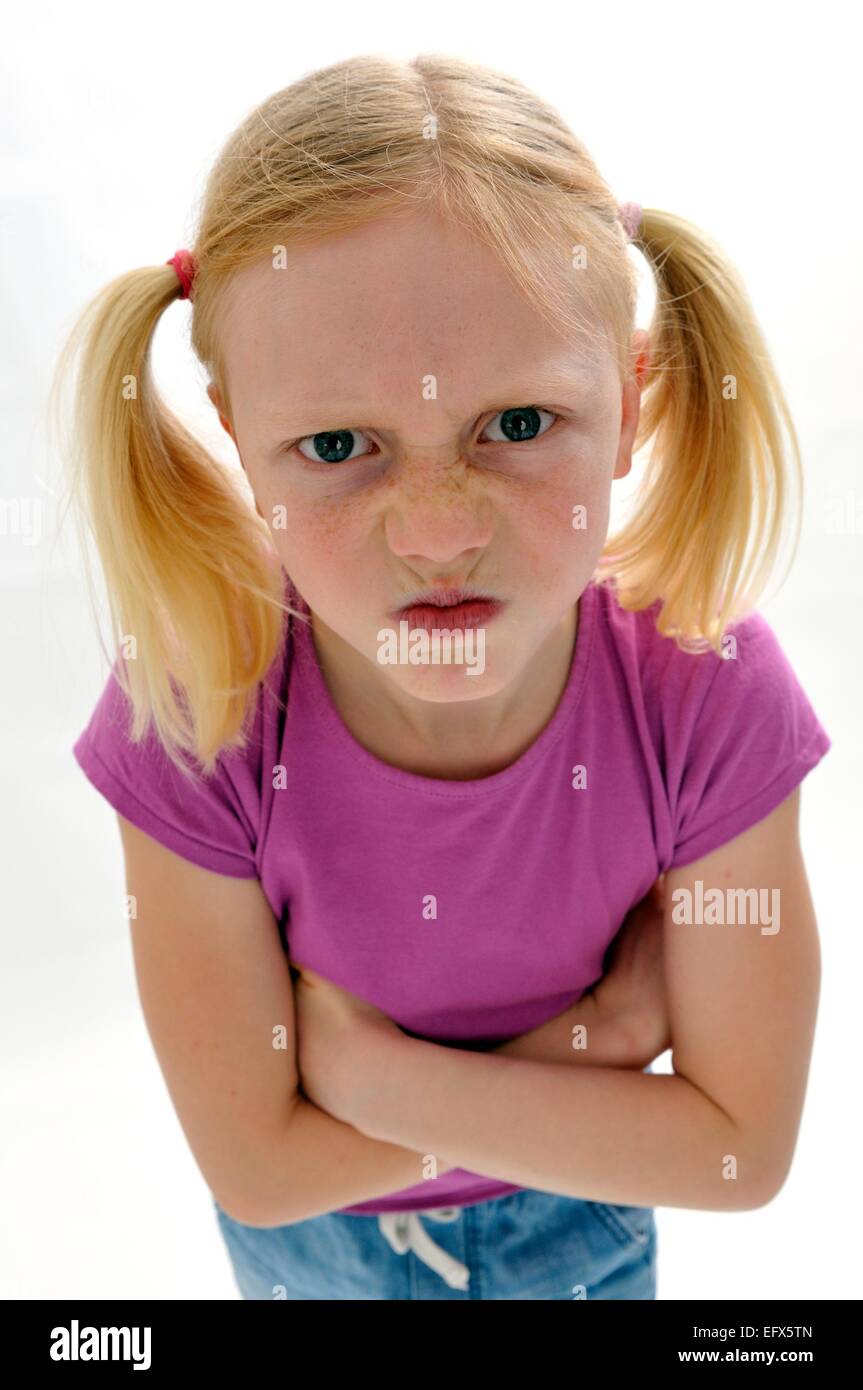 Young girl with pig tails angry bad tempered Stock Photo