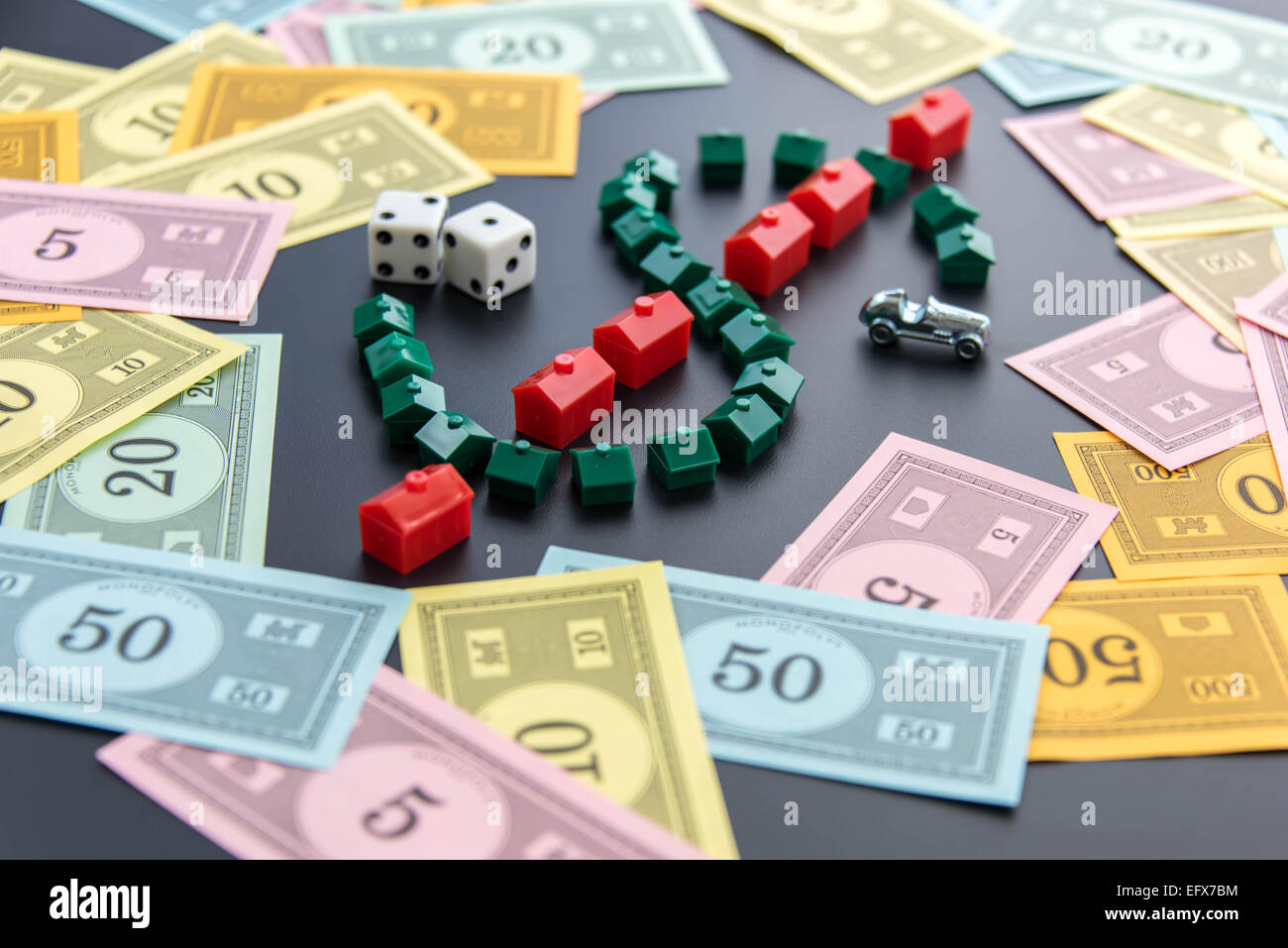 February 8, 2015 - Houston, TX, USA.  Monopoly money around houses and hotels Stock Photo