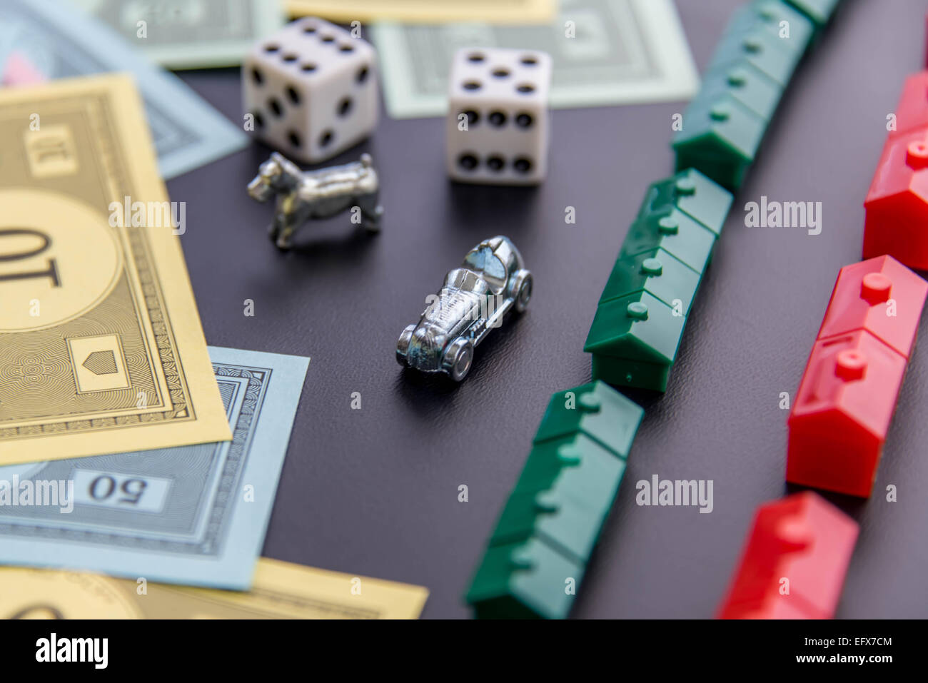 February 8, 2015 - Houston, TX, USA.  Monopoly money, playing pieces and dice Stock Photo