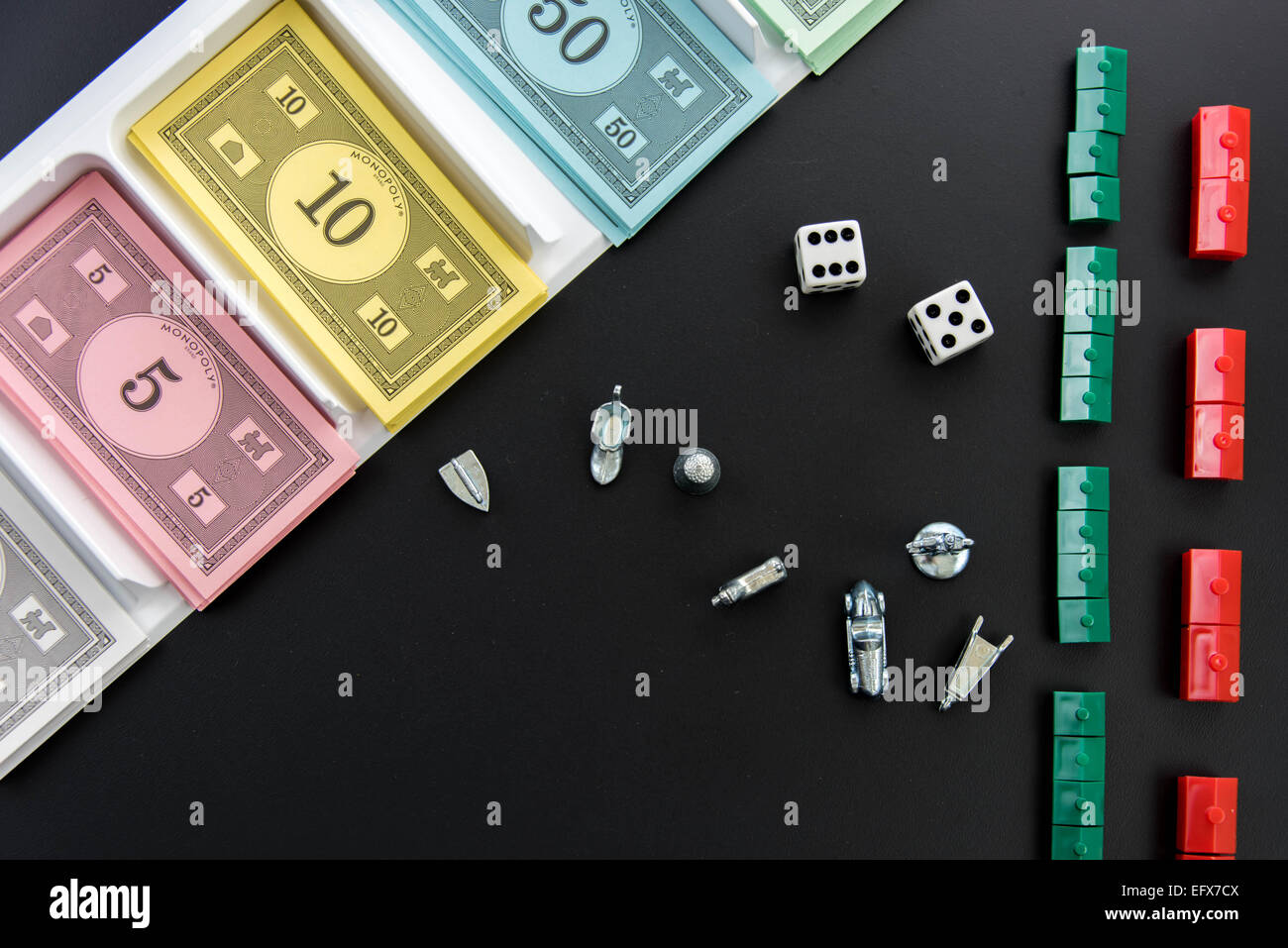February 8, 2015 - Houston, TX, USA.  Monopoly money, playing pieces and dice Stock Photo