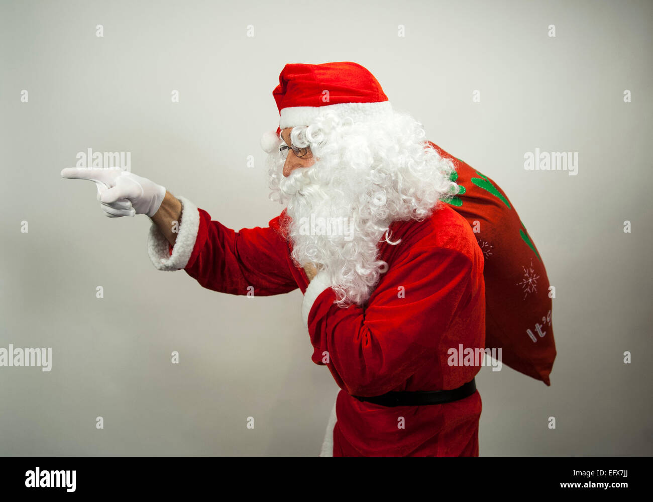 Santa claus holding bag toys hi-res stock photography and images - Alamy