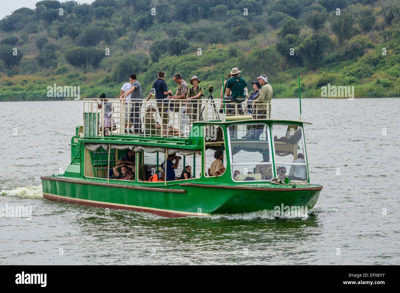 Tourists on a wildlife-spotting boat trip around Lake Edward, QENP, Uganda. From the front. Stock Photo