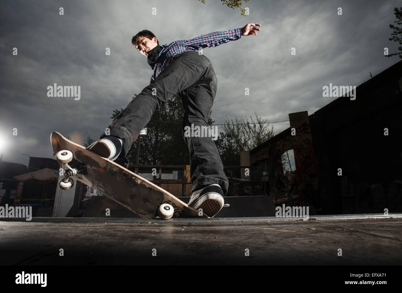 Skateboarding on mini ramp, 5-0 grind to fakie, Berlin, Germany Stock Photo