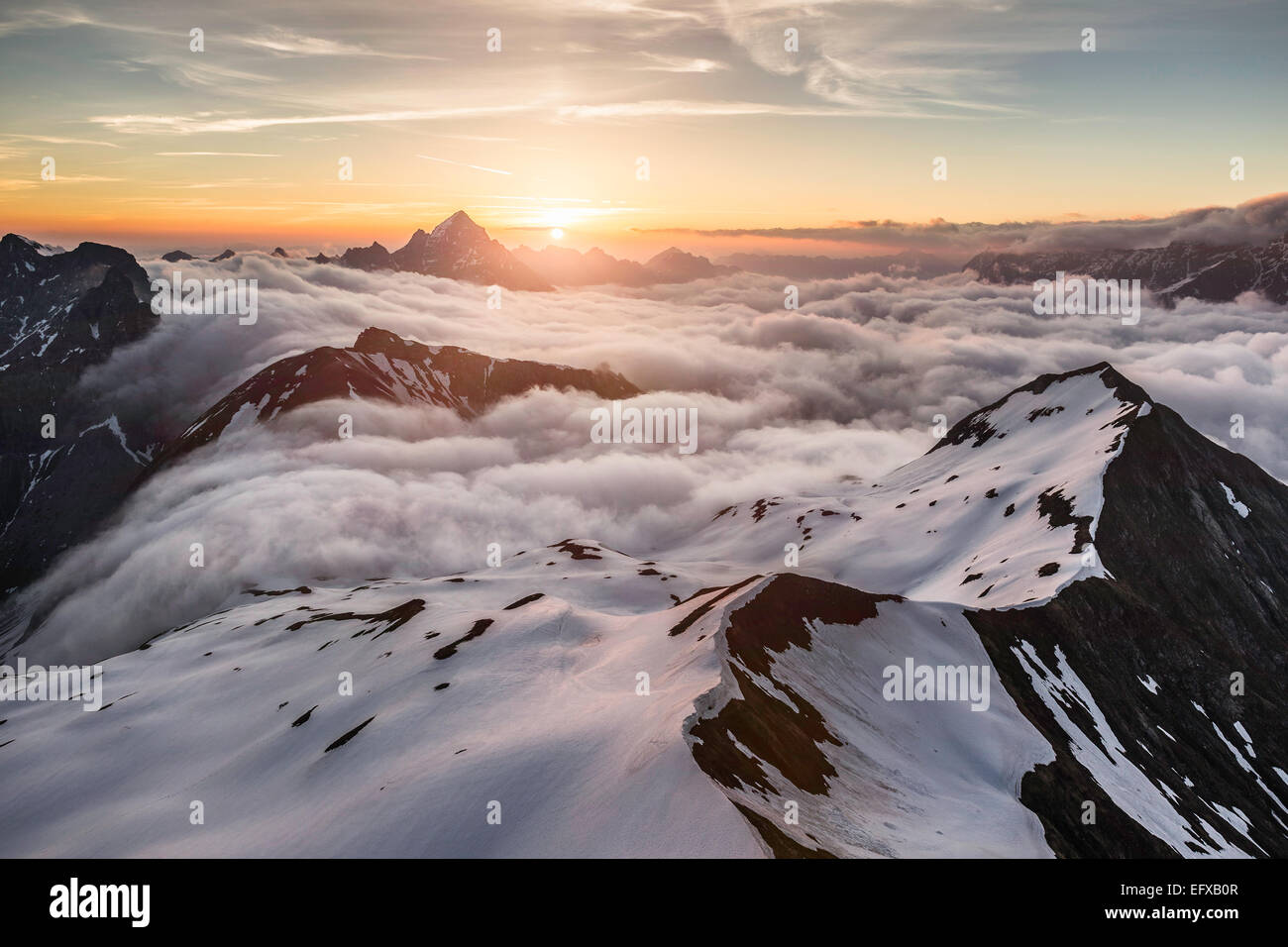 View of Bavarian Alps as sun rises above the clouds, Oberstdorf, Bavaria, Germany Stock Photo