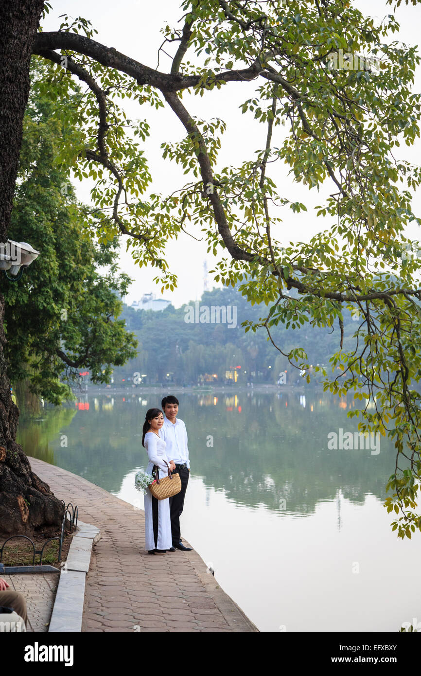 Couple at the Hoan Kiem Lake in the old quarter, Hanoi, Vietnam. Stock Photo