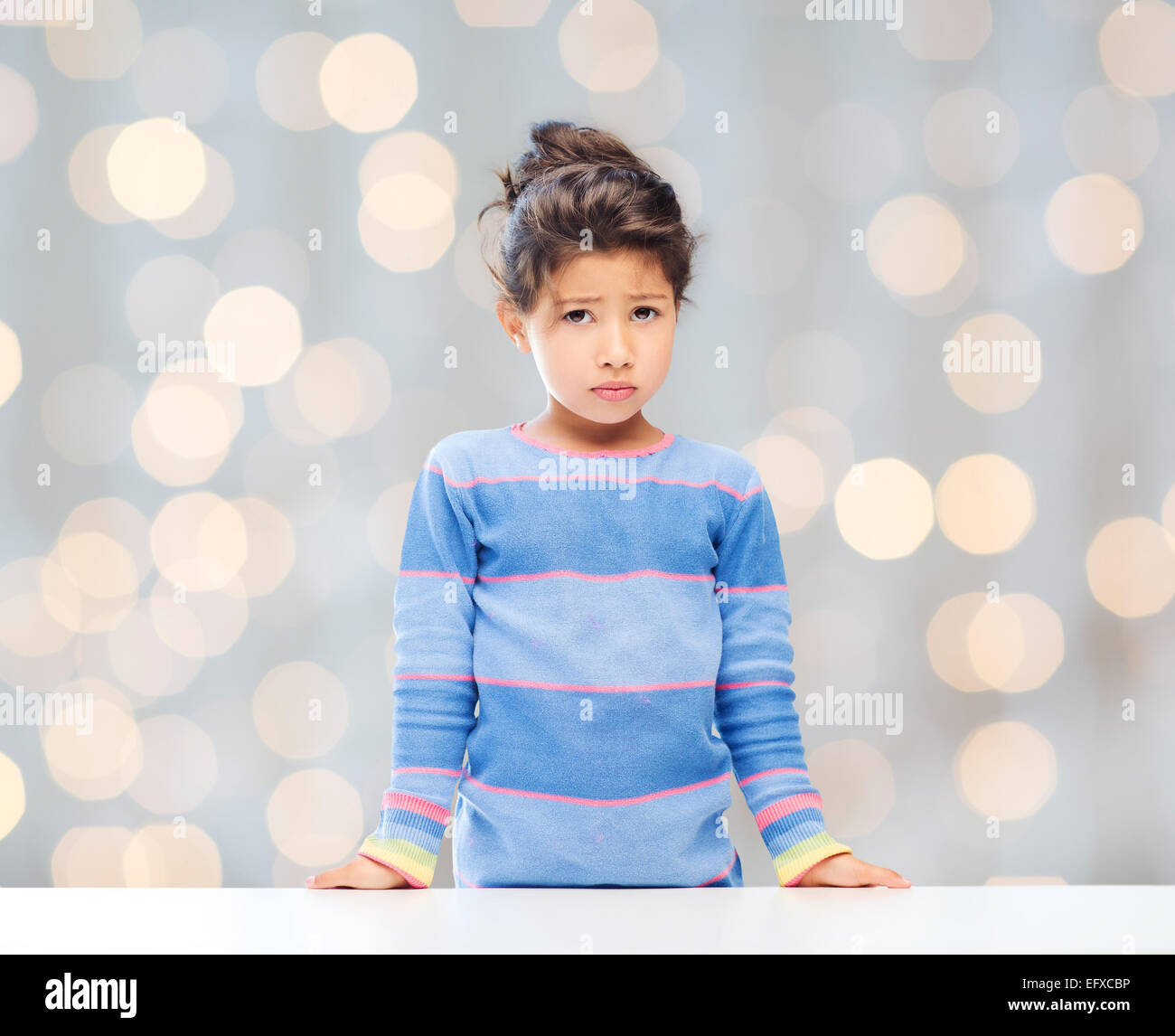 sad little girl over city background Stock Photo