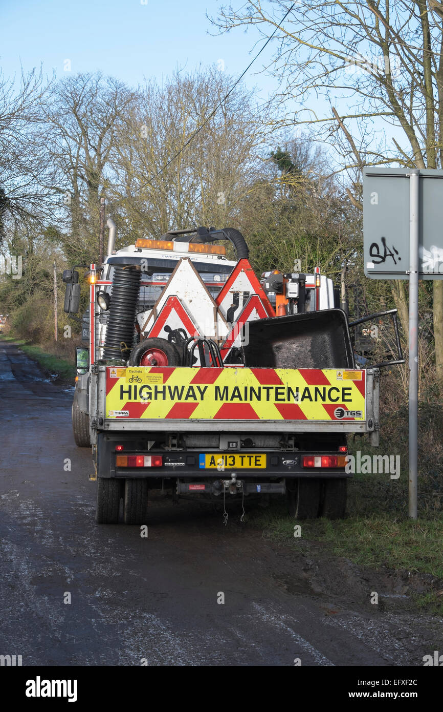 Highway maintenance vehicle carrying road works signs wheelbarrows Fen