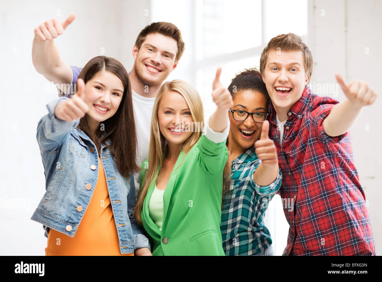 students showing thumbs up at school Stock Photo - Alamy