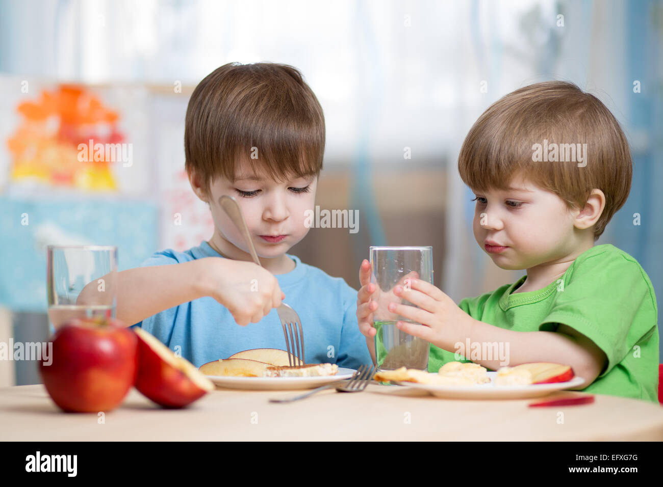 children boys eating healthy food at home Stock Photo