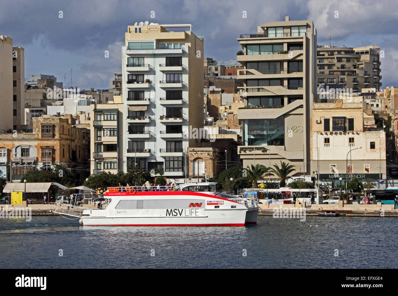 Sliema to Valletta ferry moored in Sliema, outside Marks and Spencer store, Malta Stock Photo