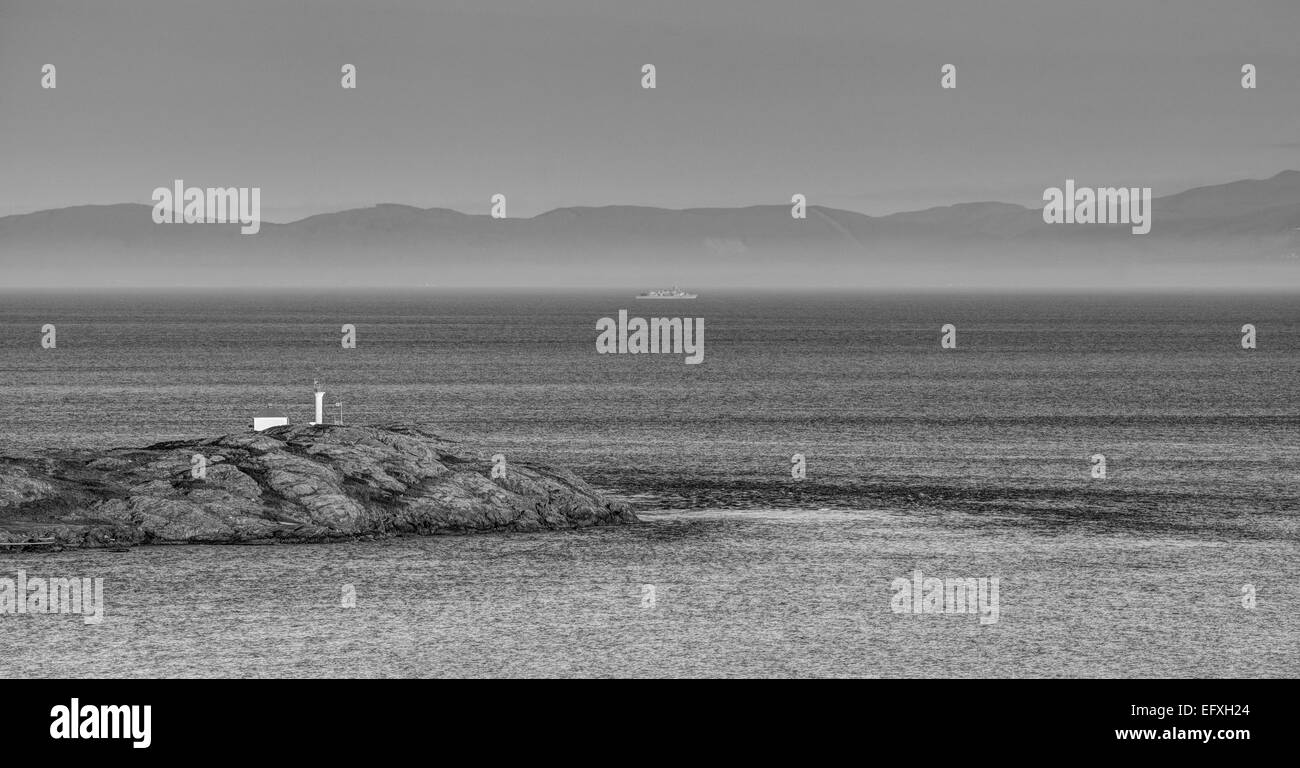 an island lighthouse near Victoria, BC, canada looking out over the Juan de Fuc Strait Stock Photo