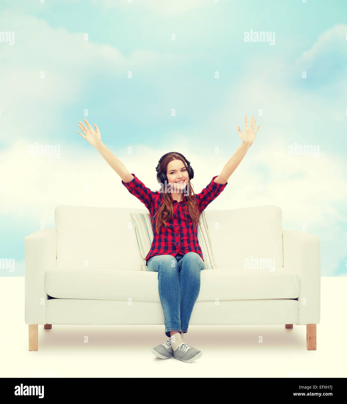 teenage girl sitting on sofa with headphones Stock Photo - Alamy
