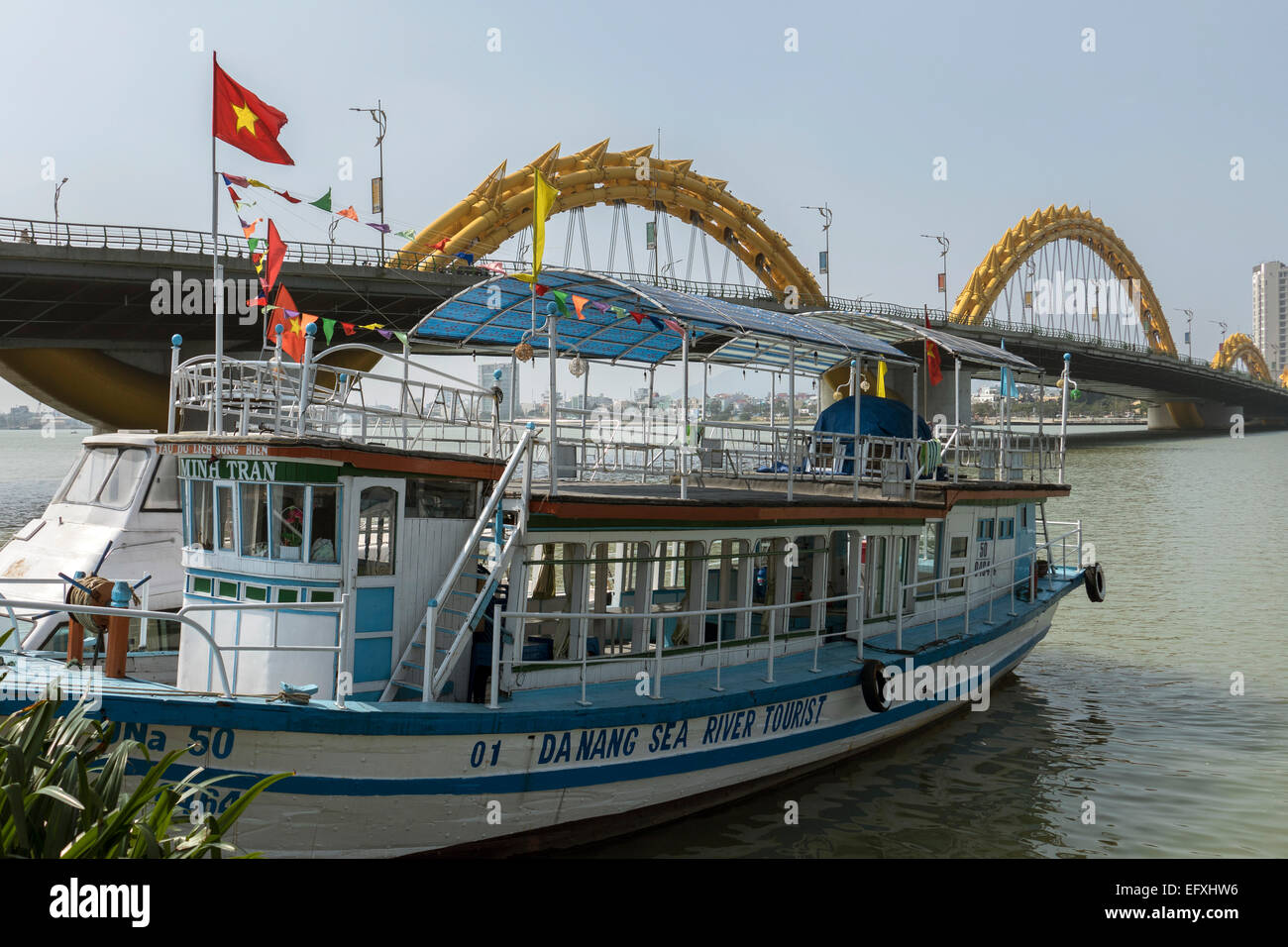 Vietnam, Danang, Pleasure boat & bridge over Song Han river Stock Photo