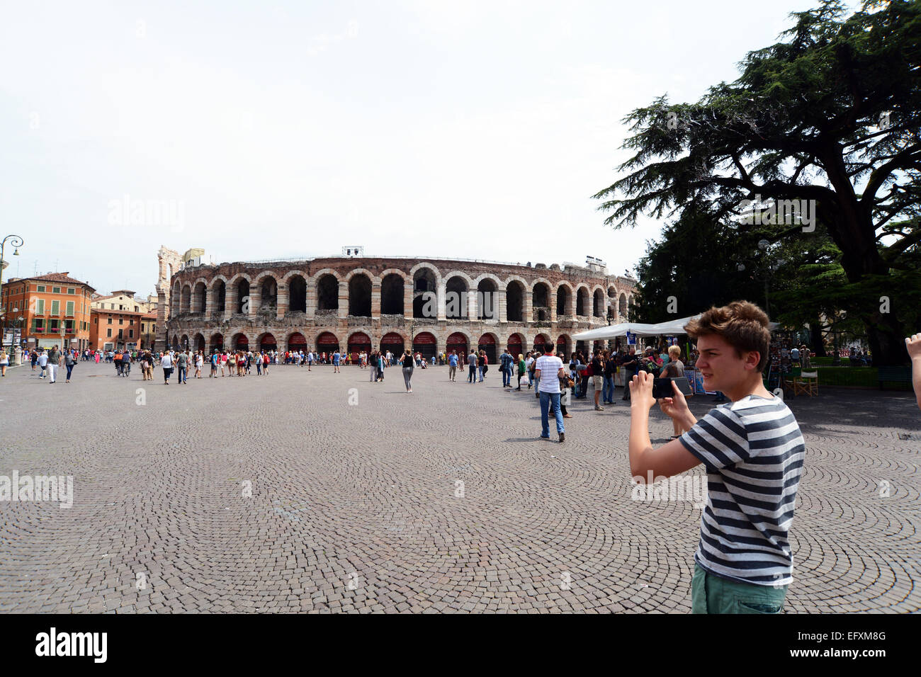 Teenage boy photographs the Verona Opera house, Italy Stock Photo