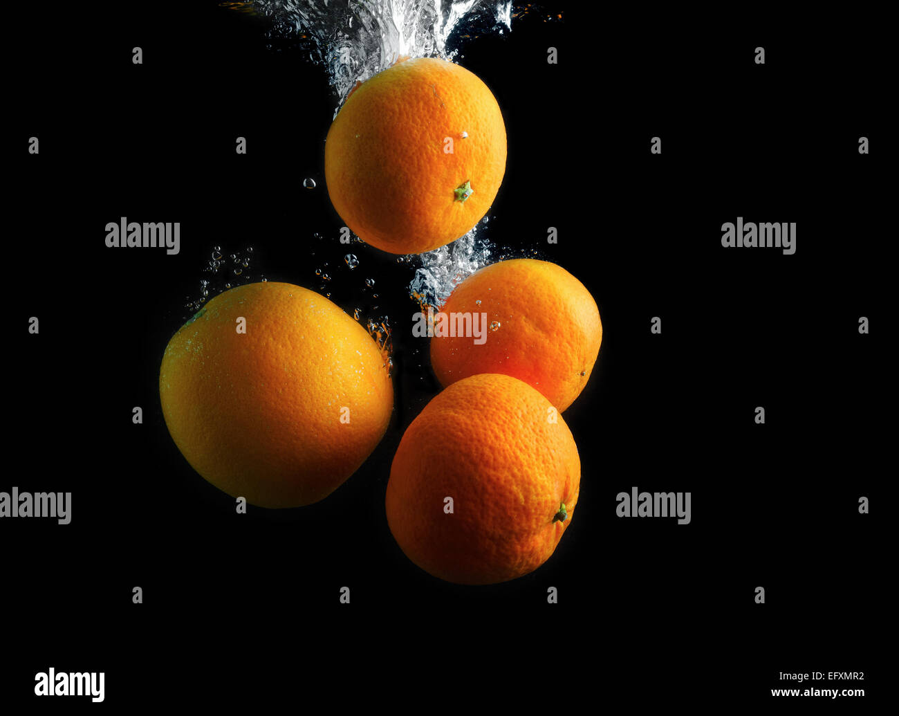 Orange and tangerines in water with air bubbles. Wash fruits. Photo on
