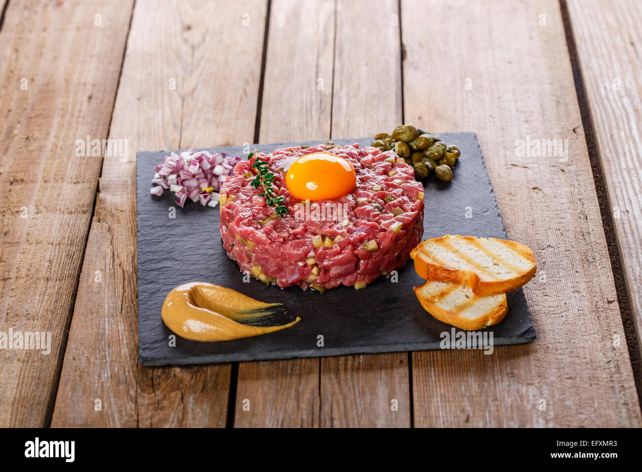 Beef tartare with capers yolk and mustard Stock Photo