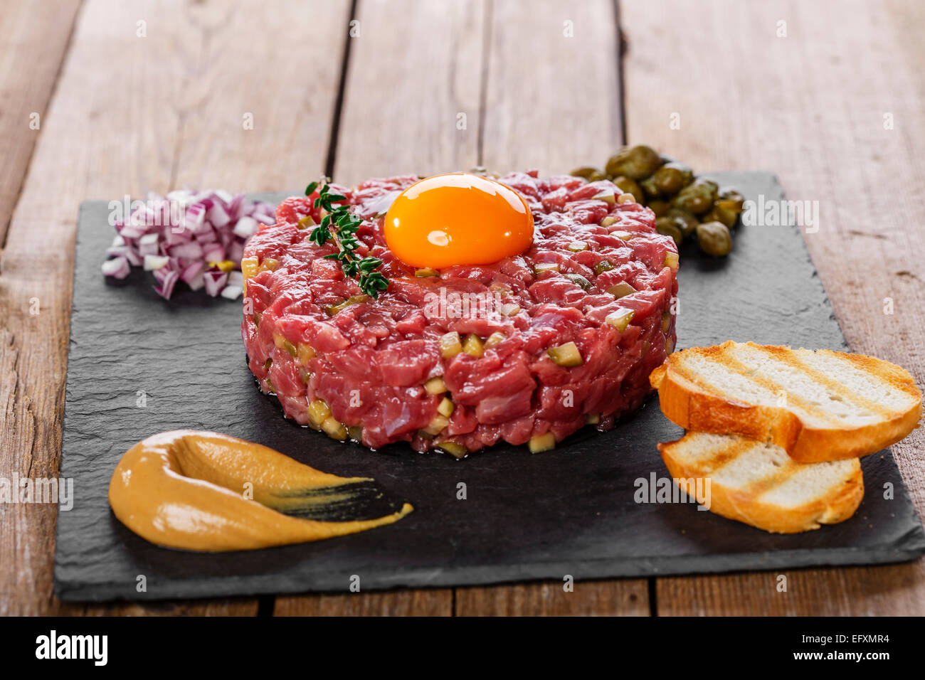 Beef tartare with capers yolk and mustard Stock Photo