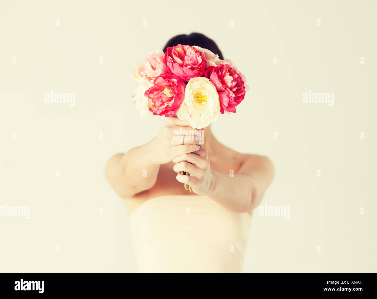 woman holding bouquet of flowers over her face Stock Photo - Alamy