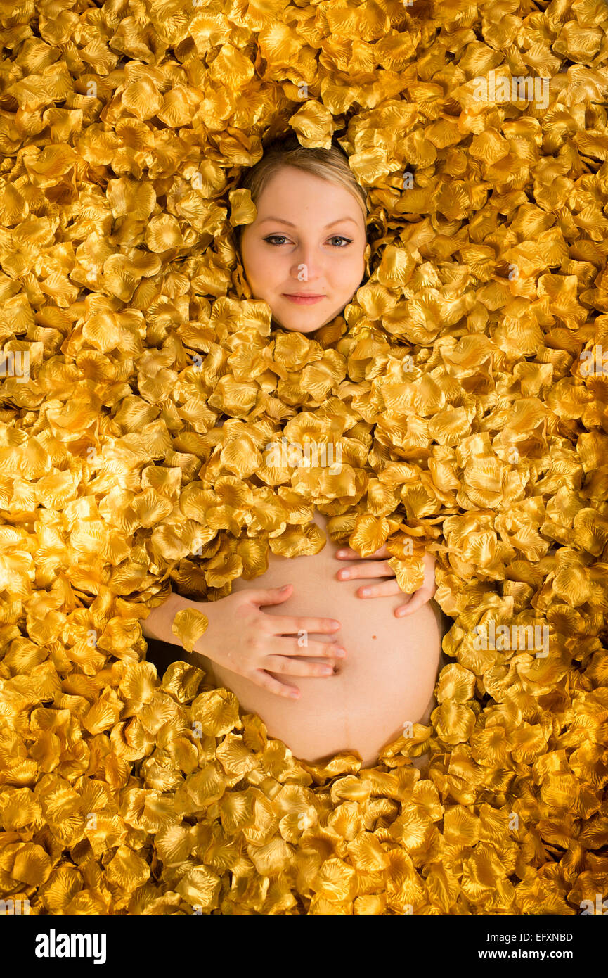 A young caucasian woman girl, 8 months pregnant, almost completely