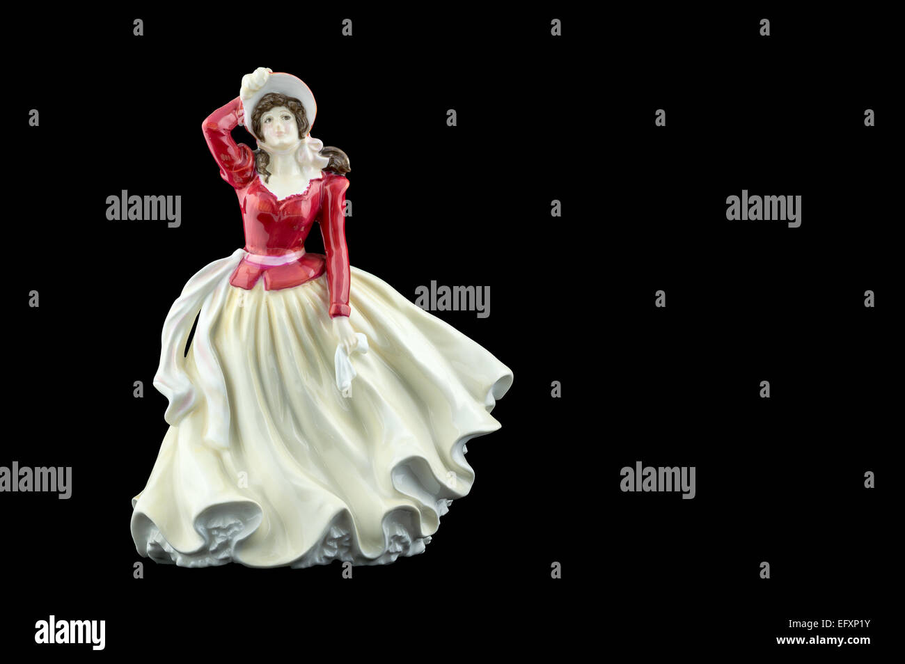 Bone china figurine wearing a Red and Cream Dress Stock Photo