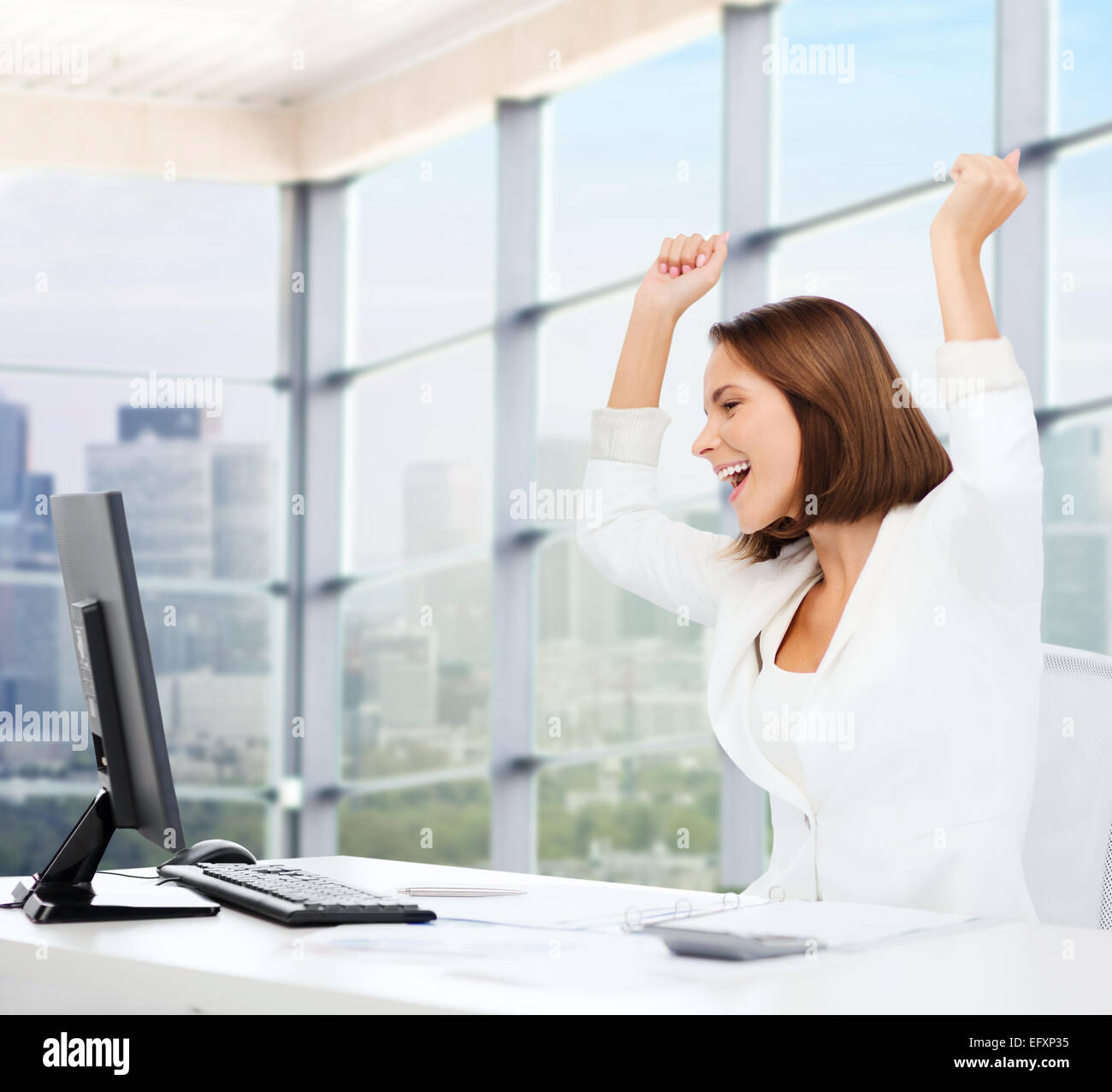 happy businesswoman with computer in office Stock Photo