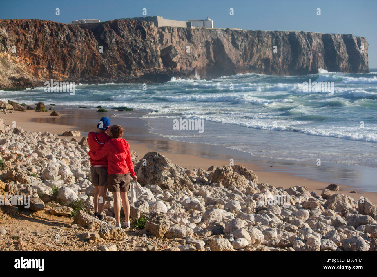 Praia do Tonel young couple on beach in evening Sagres Algarve Costa Vicentina Portugal Stock Photo