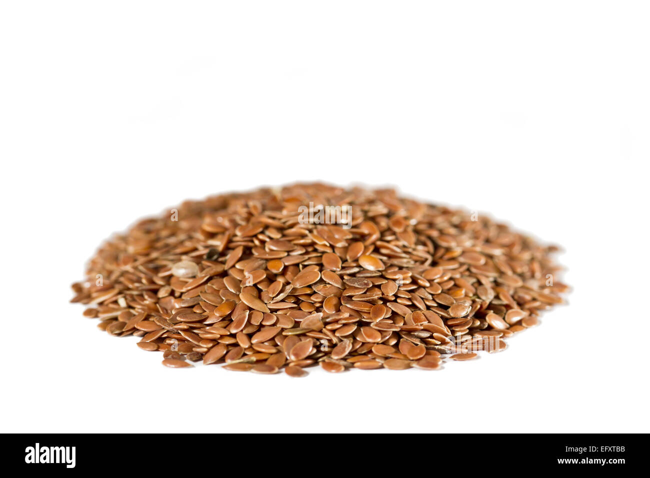 A heap of dried brown flax seeds. White background. Flax is also known