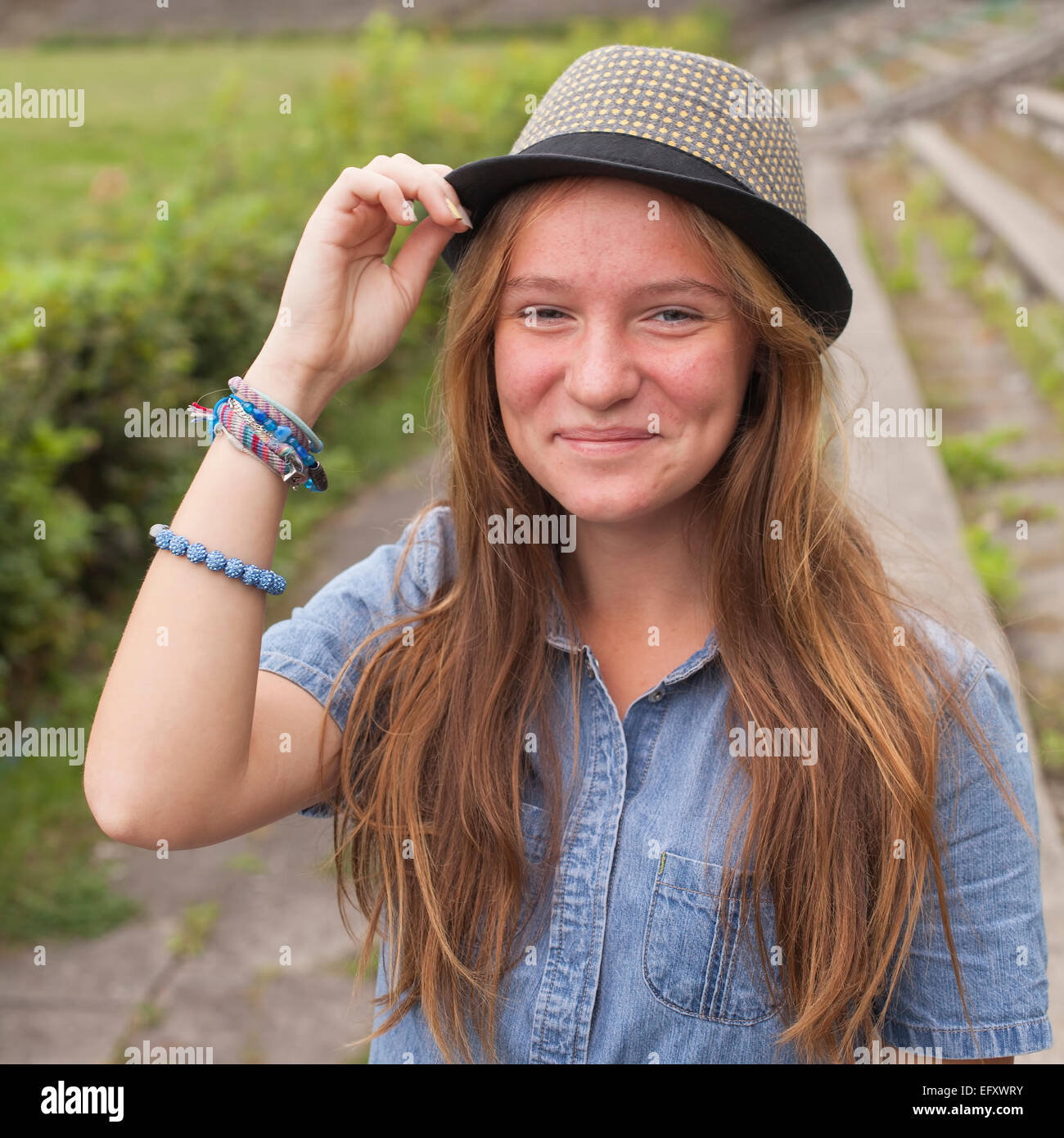Cute teen girl wearing a hat, outdoors in the park (square series Stock