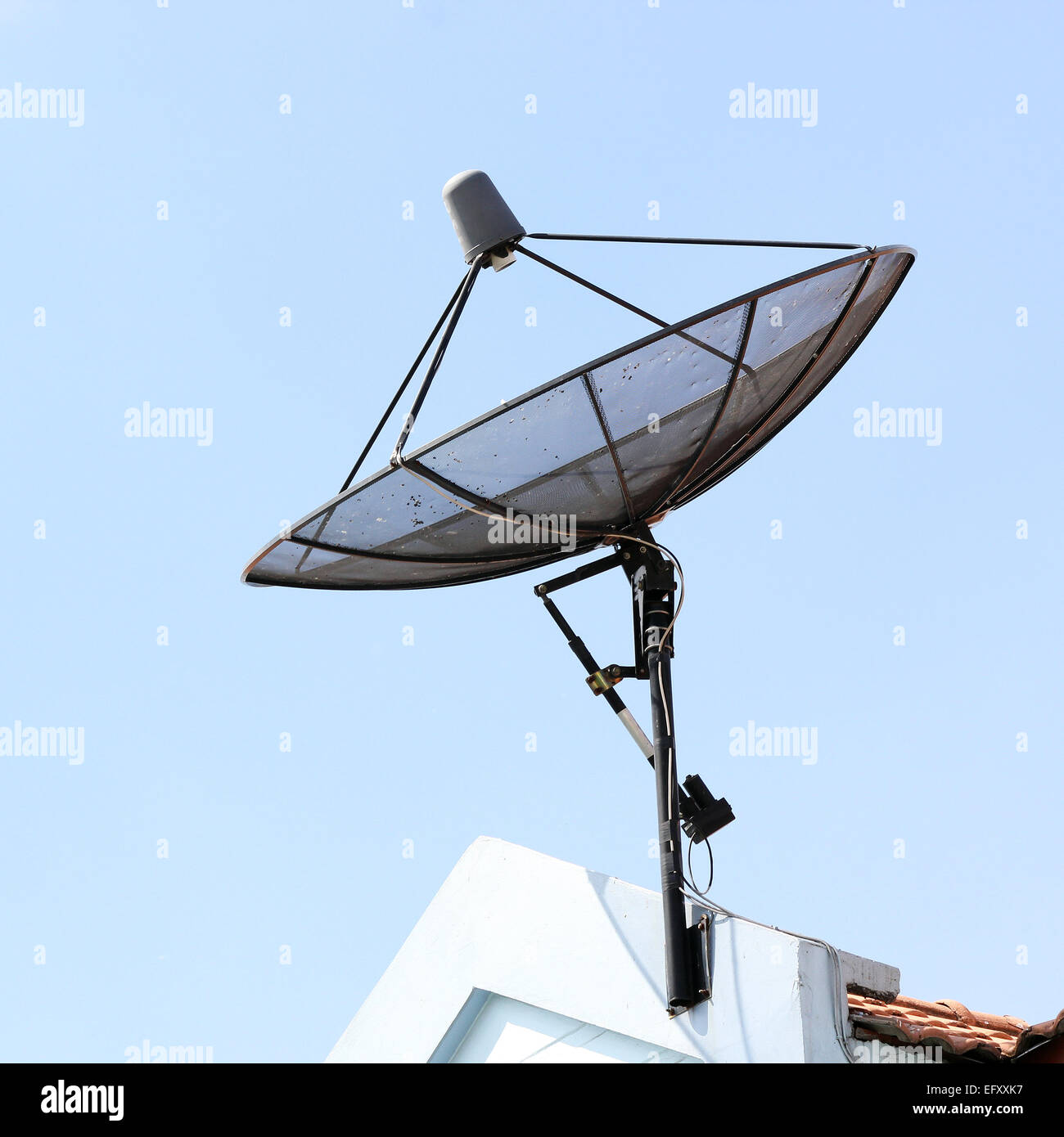 Satellite dish on roof with beautiful sky Stock Photo