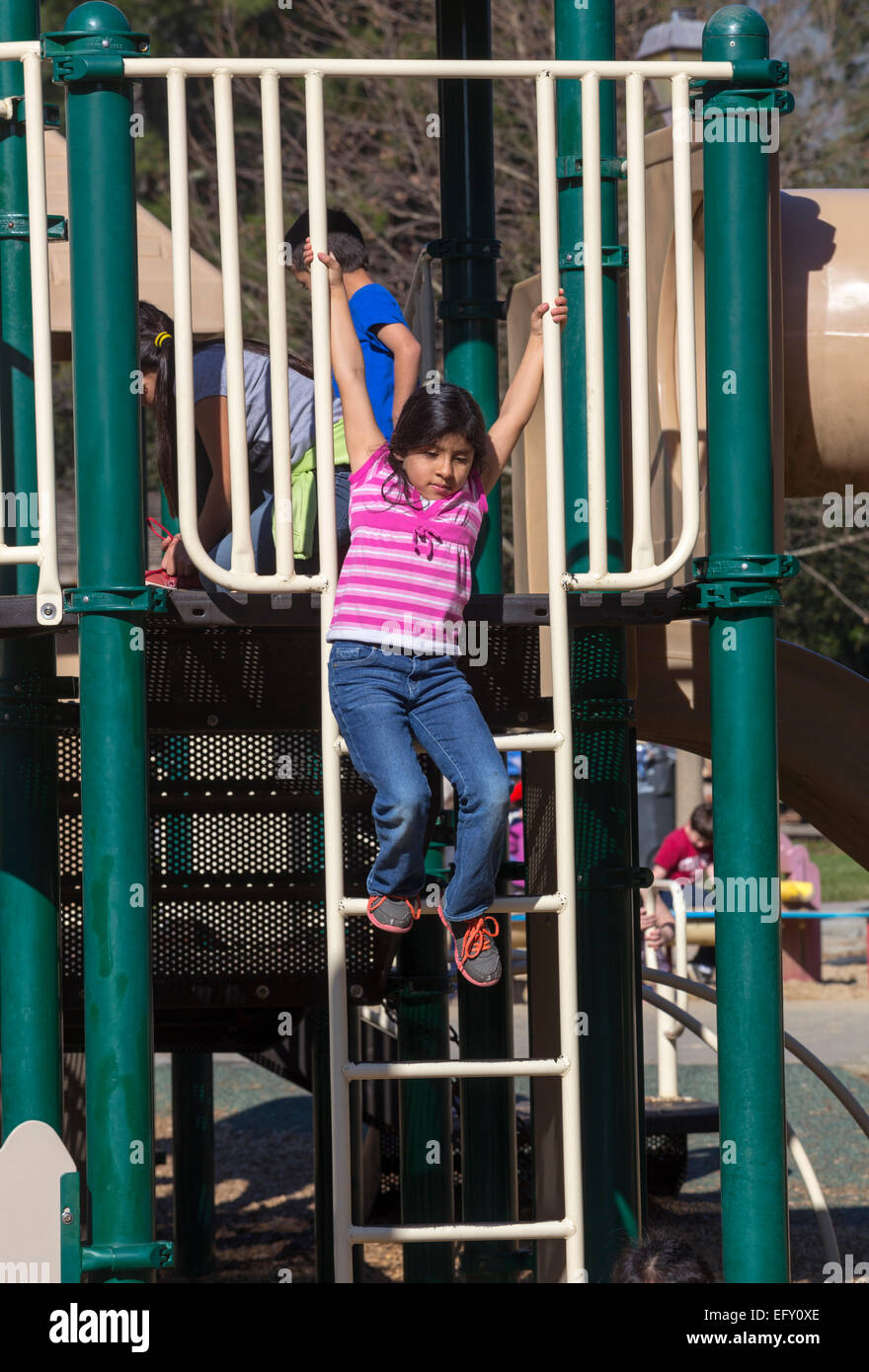 Hispanic girl, young girl, girl, climbing down ladder, playground, Pioneer Park, Novato, California Stock Photo