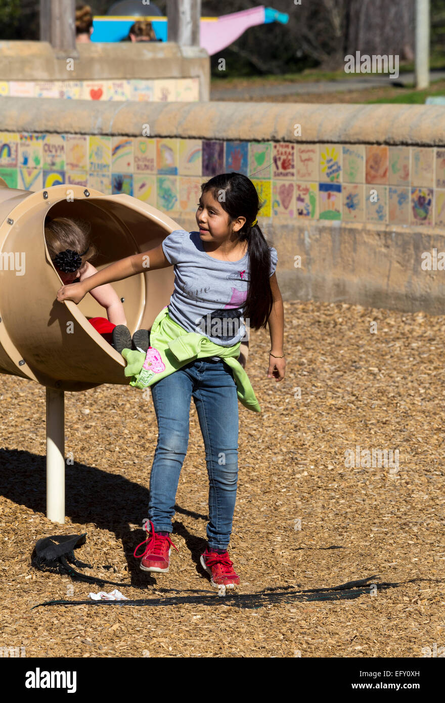 Hispanic girl, young girl, girl, tubular slide, playground, Pioneer Park, Novato, California, United States, North America Stock Photo
