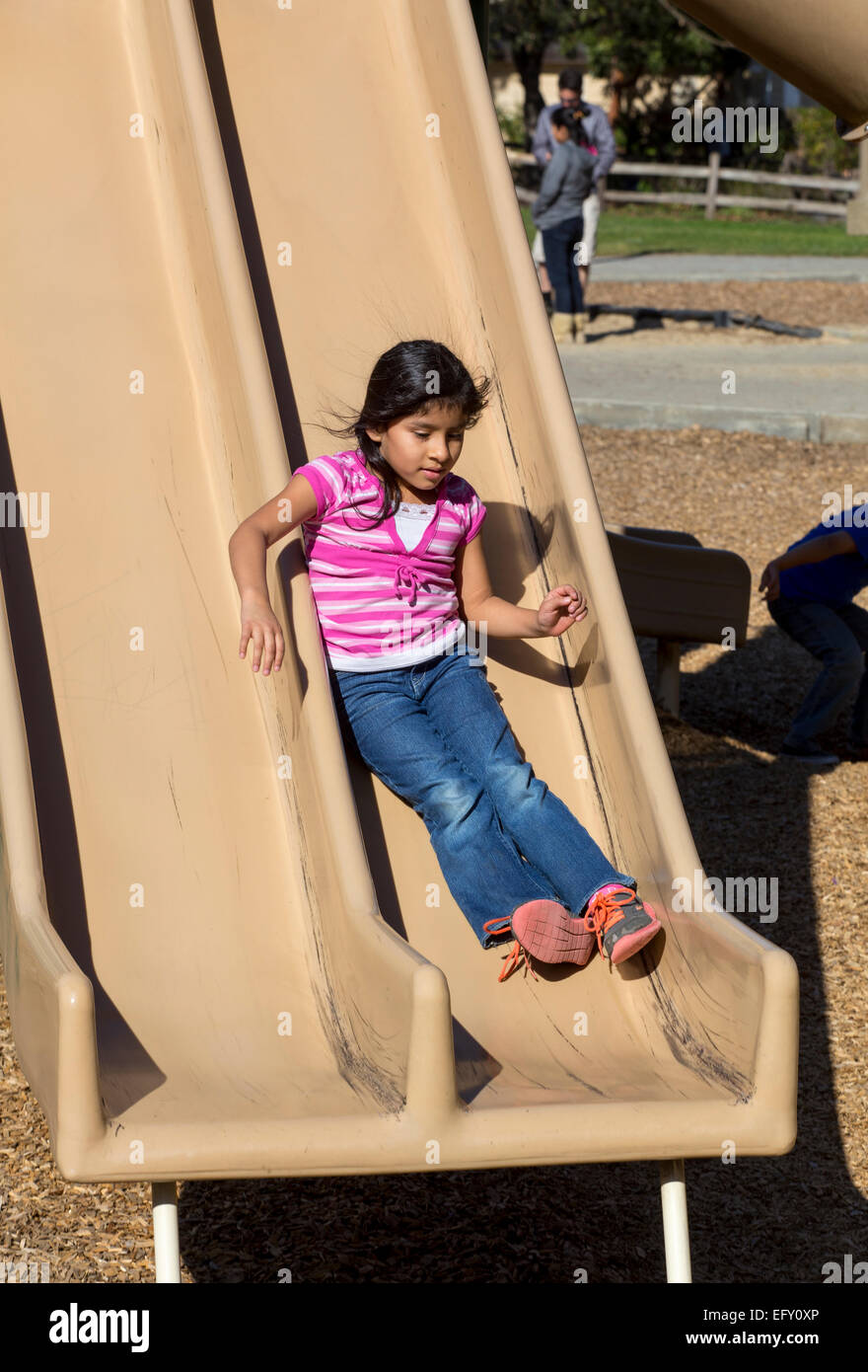 Hispanic girl, young girl, girl, sliding pond, playground, Pioneer Park, Novato, California, United States, North America Stock Photo