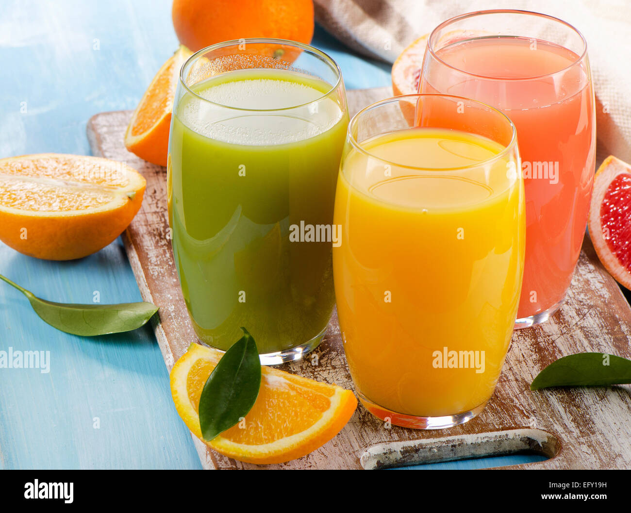 Citrus juice and fruits  on wooden background. Selective focus Stock Photo