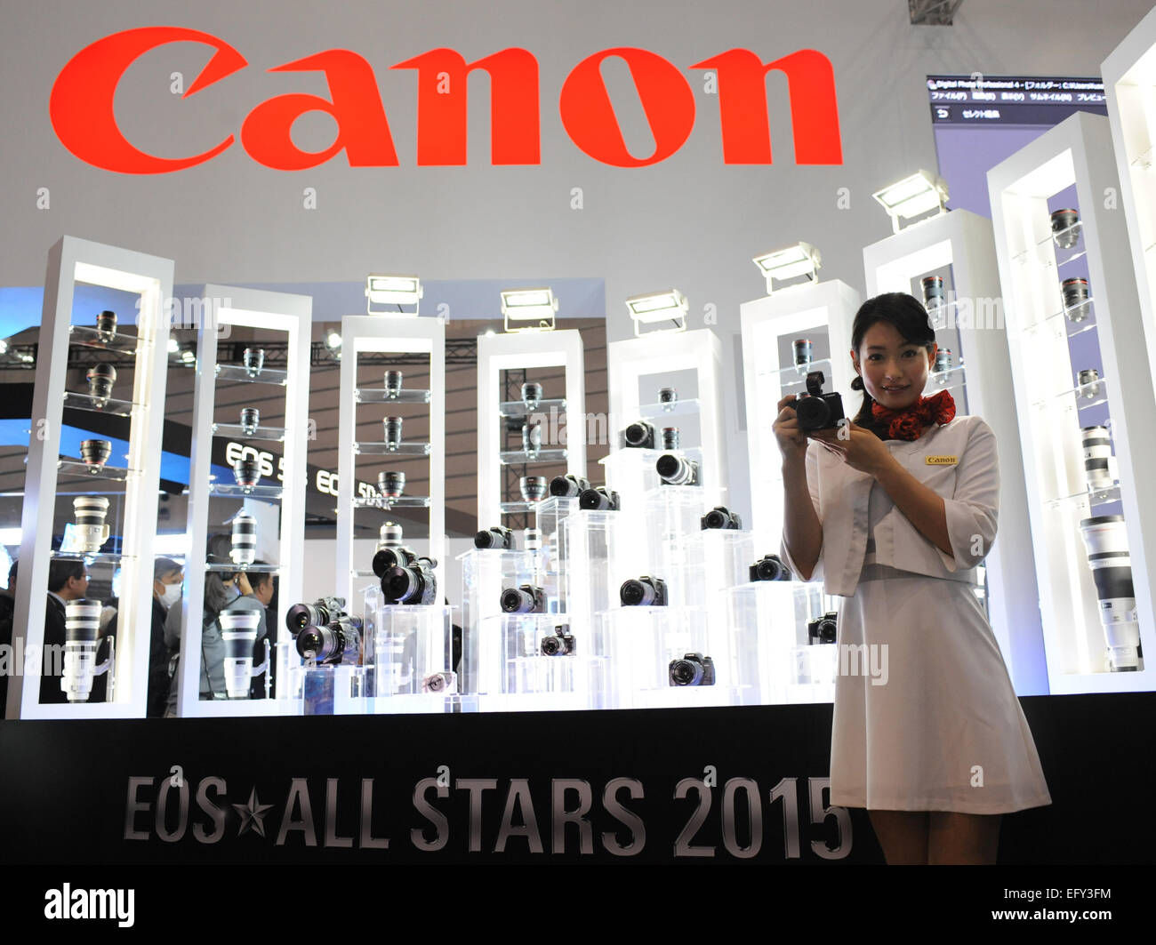 Tokyo, Japan. 12th Feb, 2015. A model poses for photos with a Canon product at the CP  Camera and Photo Imaging Show in Yokohama, Japan, Feb. 12, 2015. The four-day exhibition was opened on Feb. 12. Credit:  Stringer/Xinhua/Alamy Live News Stock Photo