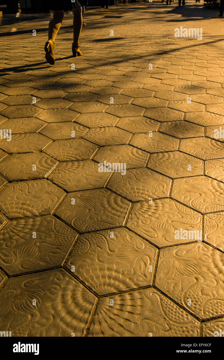 Sunset view of the tiled sidewalk in Passeig de Gracia, Barcelona, Catalonia, Spain Stock Photo