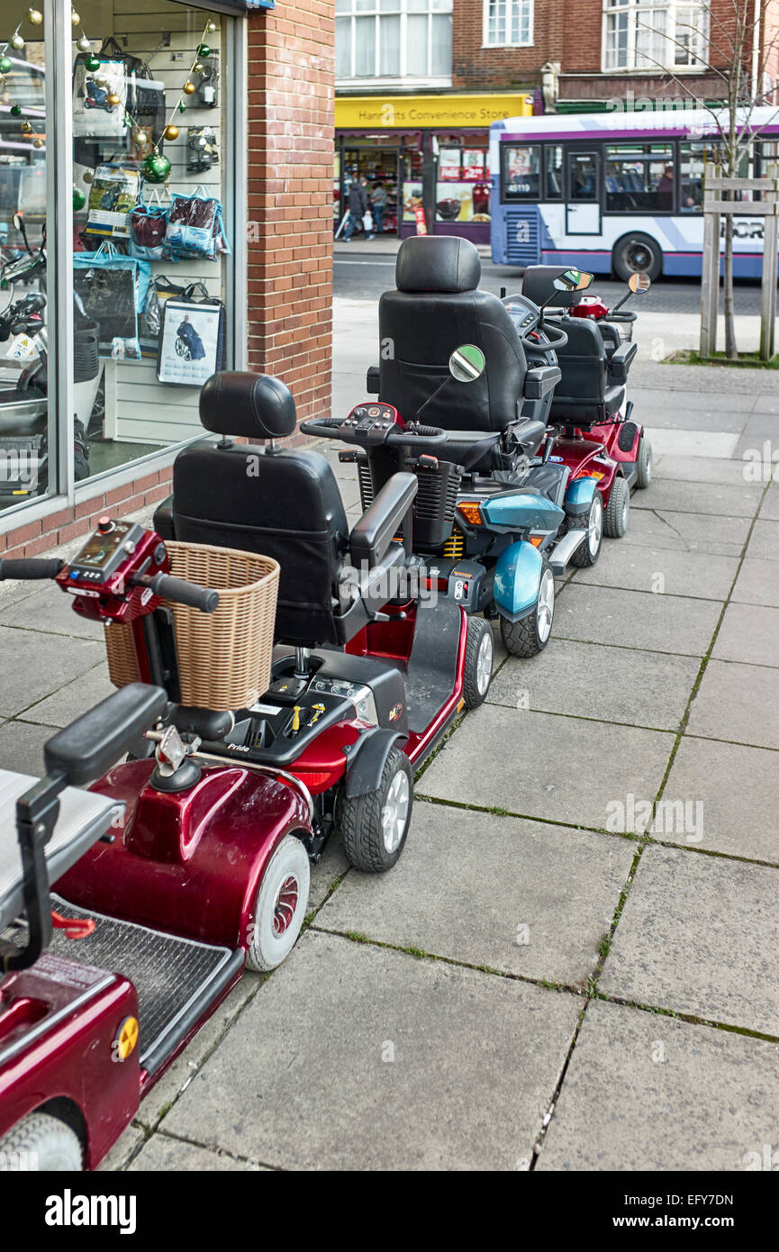 Mobility scooters outside shop in Norwich Stock Photo