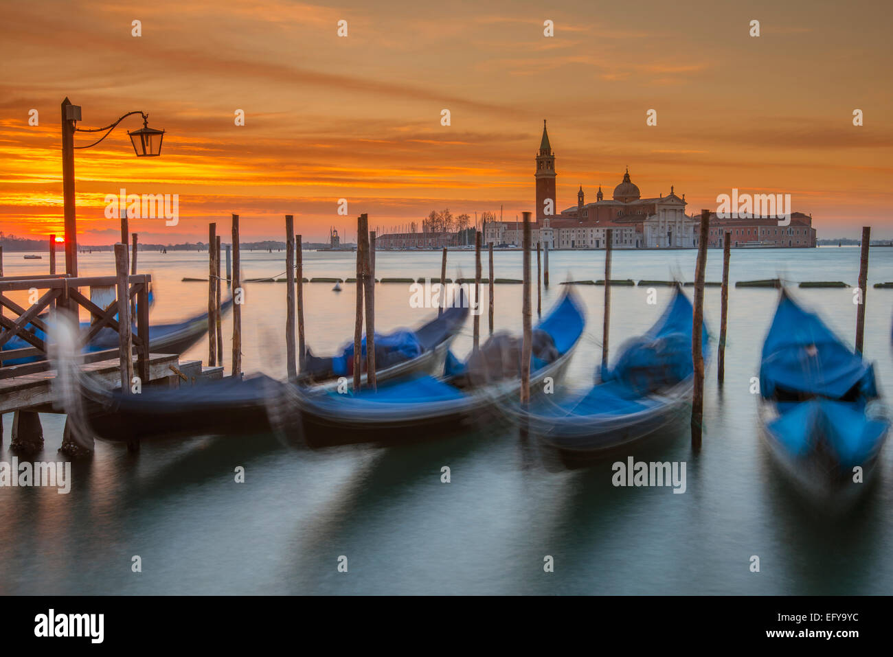 Moored gondolas with San Giorgio Maggiore island in the background at dawn, Venice, Veneto, Italy Stock Photo