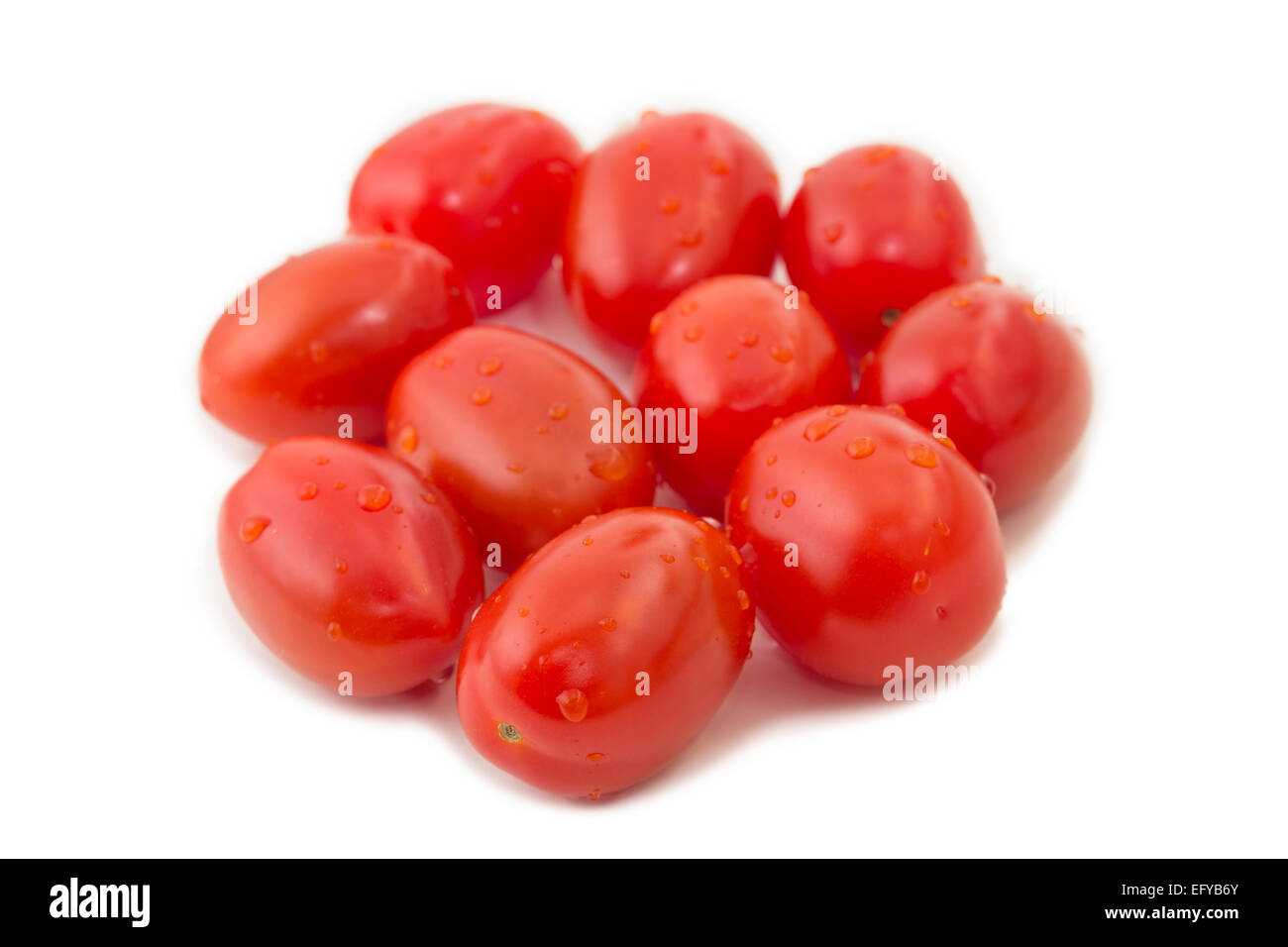 Closeup of several ripe plum tomatoes (also known as a processing tomatoes or paste tomatoes), isolated on white background Stock Photo