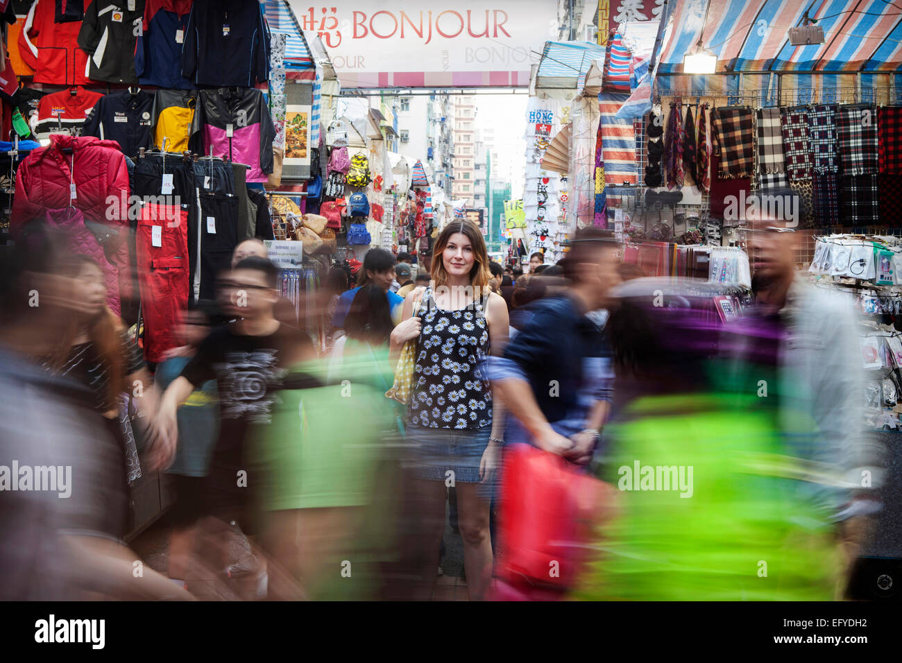 A woman shopping in a crowded street market in Hong Kong Stock Photo