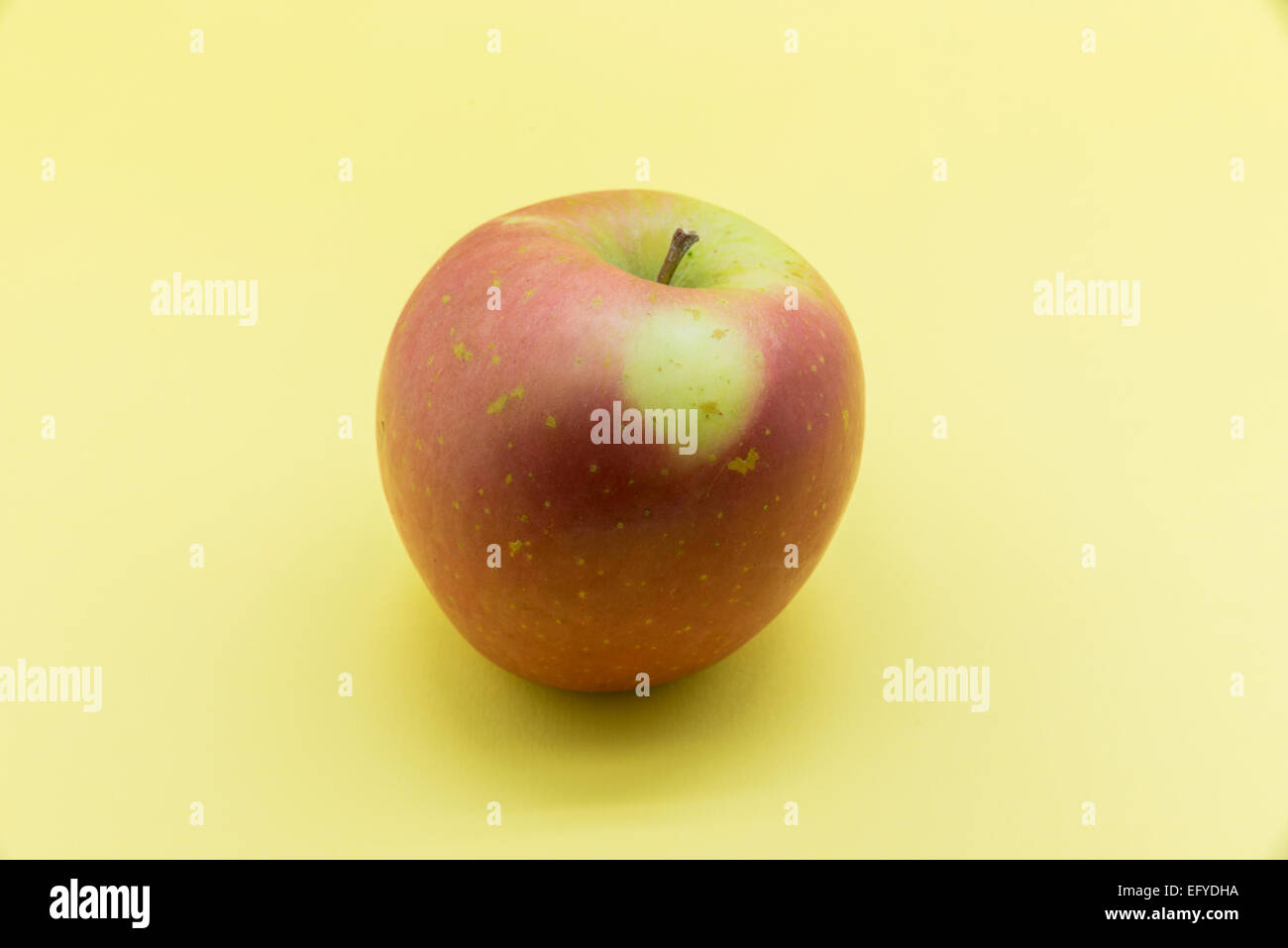 ripe apple on a yellow background Stock Photo